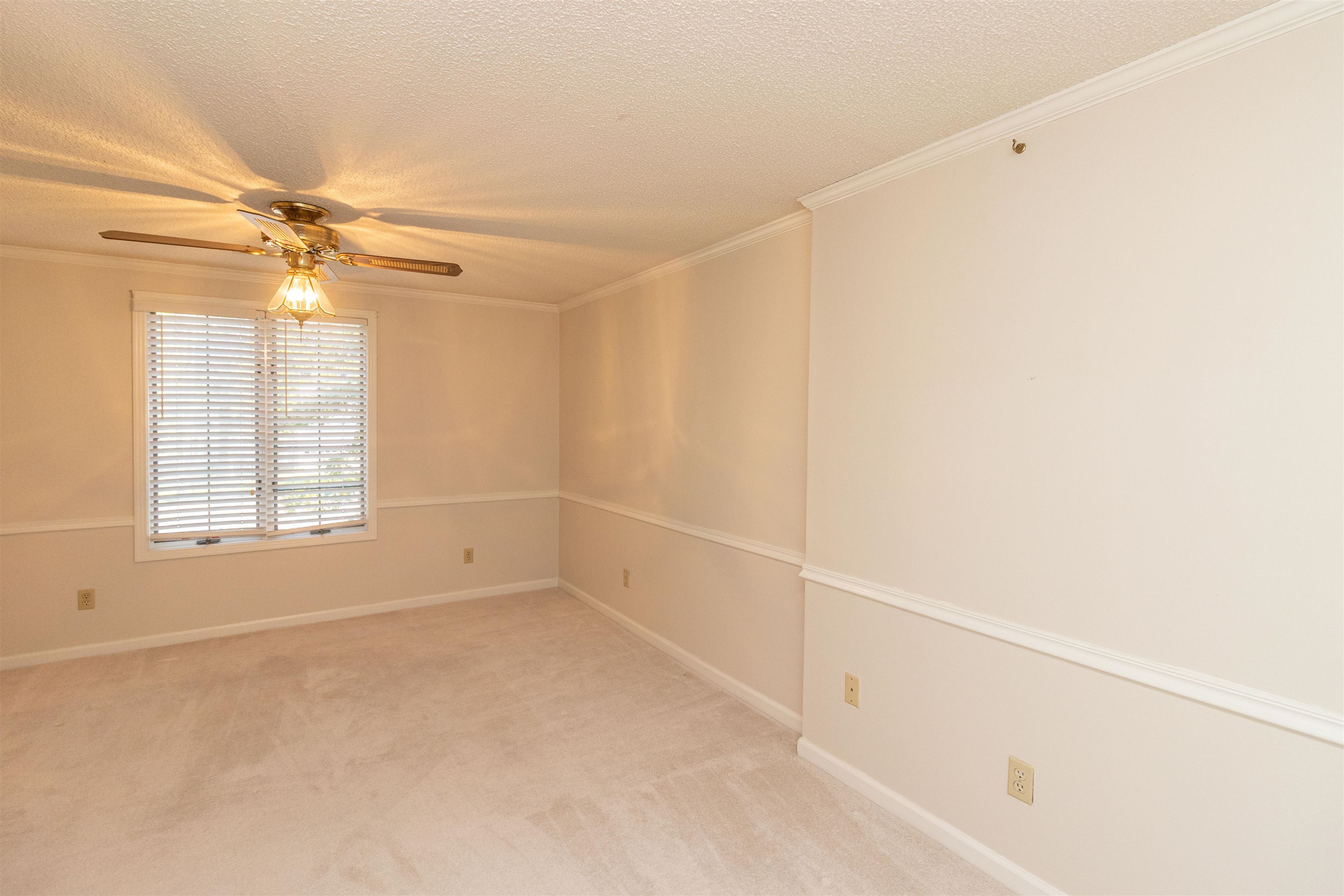 651 Pine Street Adamsville, TN 38310 - Photo 18 of 25 an empty room with windows and fan