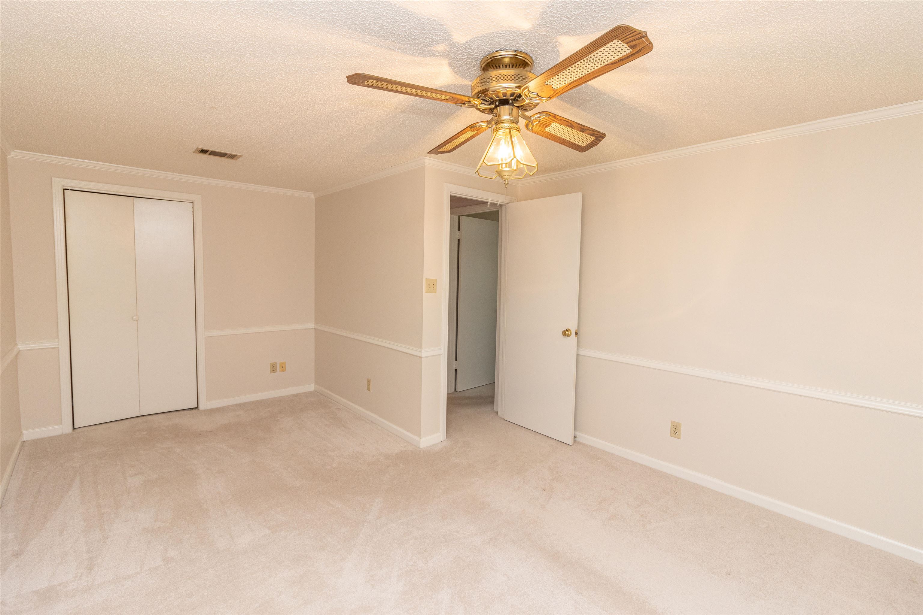651 Pine Street Adamsville, TN 38310 - Photo 19 of 25 an empty room with closet and a chandelier fan