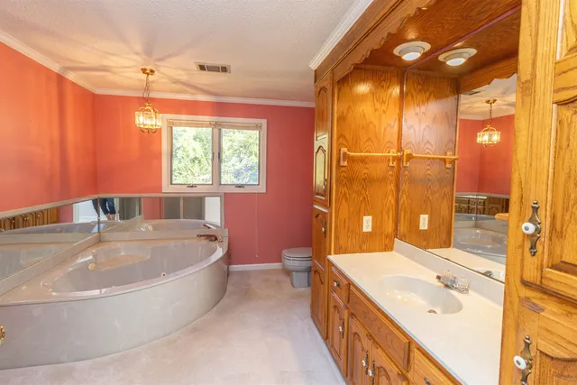 a spacious bathroom with a tub sink shower and mirror