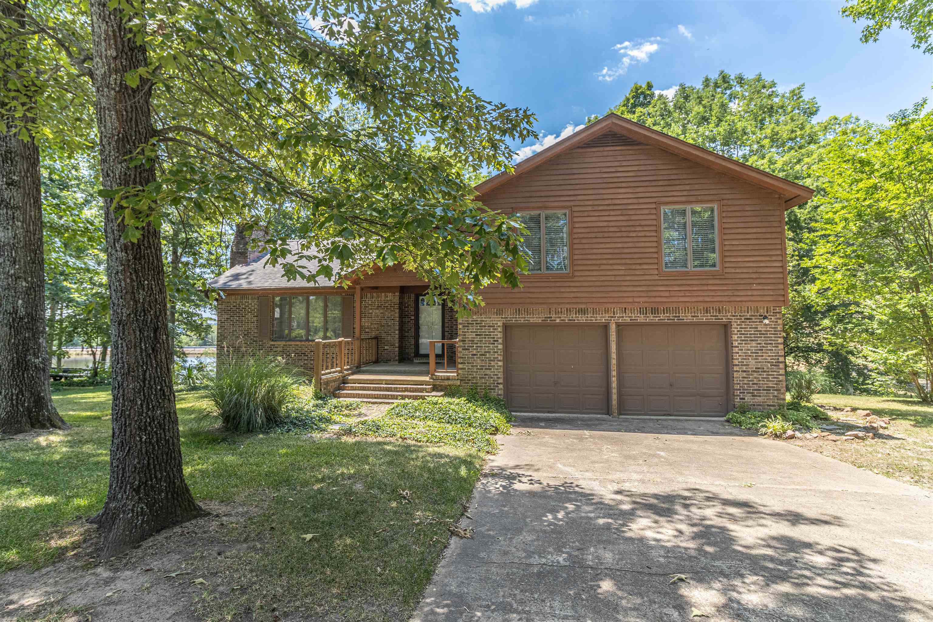 651 Pine Street Adamsville, TN 38310 - Photo 2 of 25 a front view of a house with a yard and trees