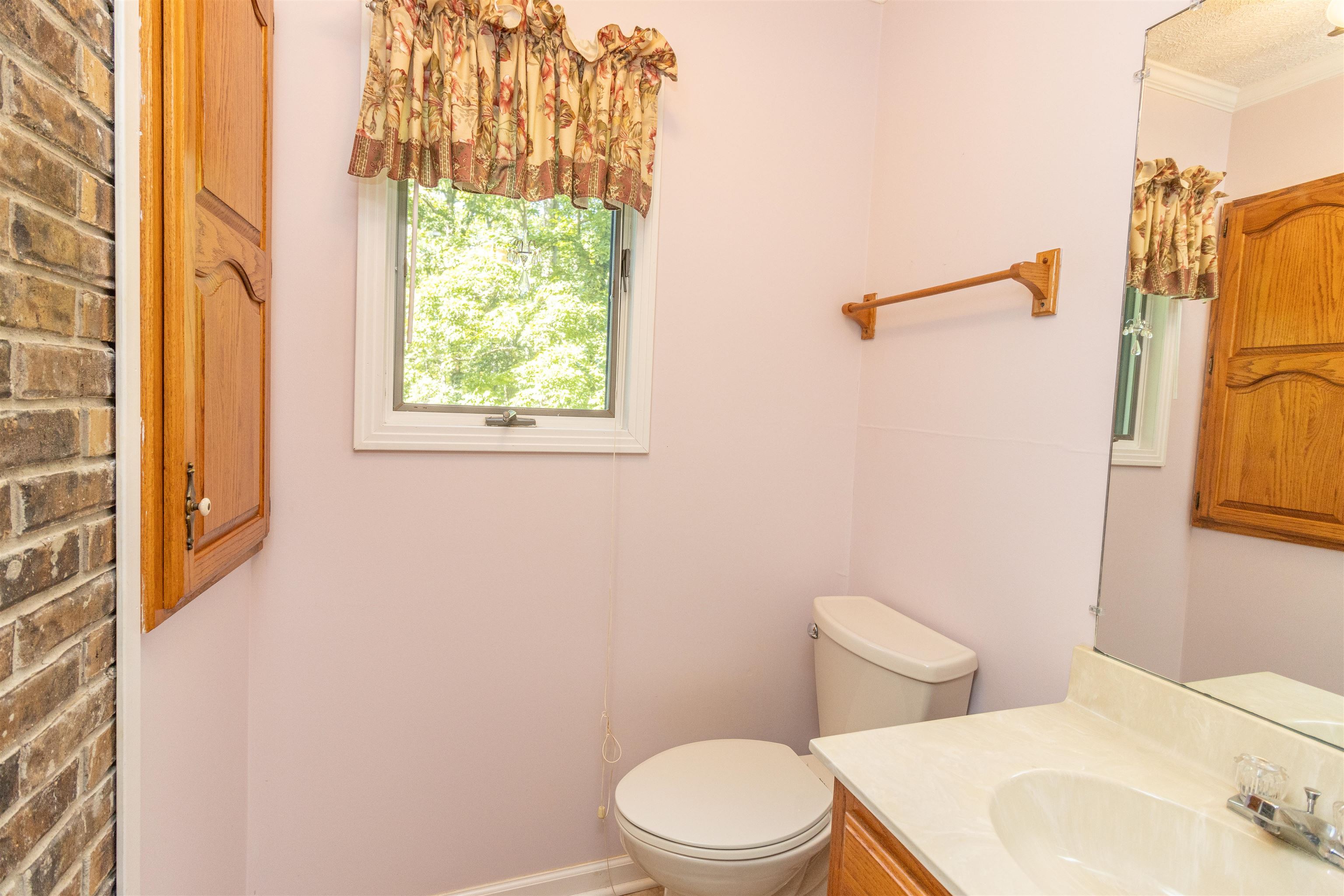 651 Pine Street Adamsville, TN 38310 - Photo 22 of 25 a white toilet sitting next to a bathroom sink