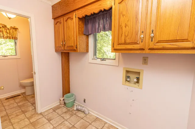 a view of a storage & utility room with a window