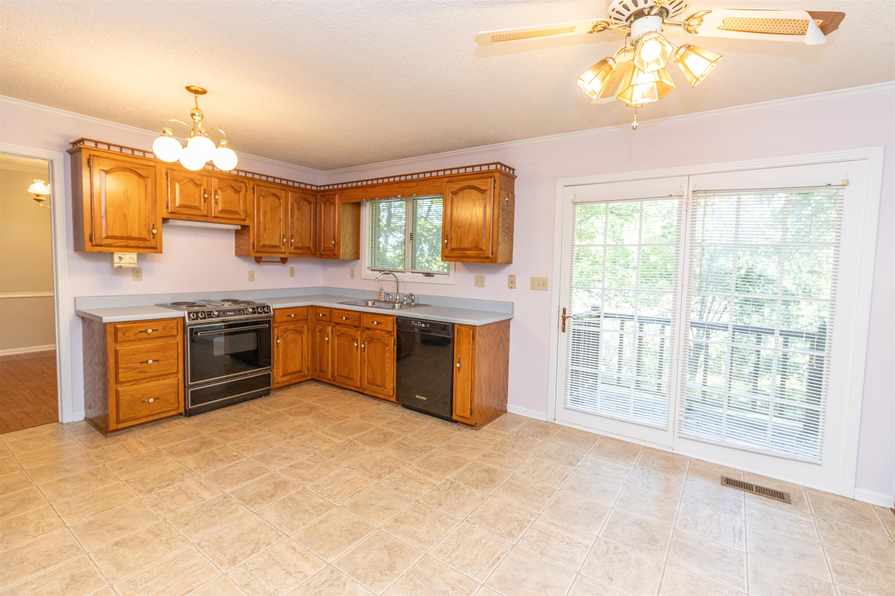 651 Pine Street Adamsville, TN 38310 - Photo 10 of 25 a kitchen with stainless steel appliances granite countertop a stove and a large cabinets