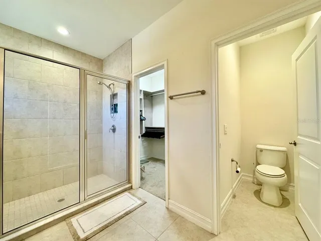 a bathroom with a shower and a toilet