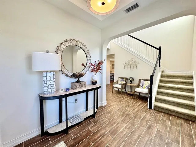 a view of a hardwood floor and an entryway