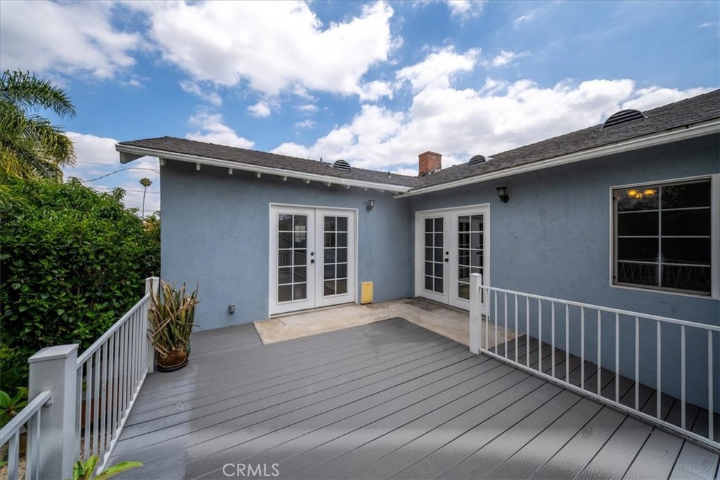 6481 Dos Rios Road Downey, CA 90240 - Photo 12 of 27 a view of a house with wooden deck and furniture