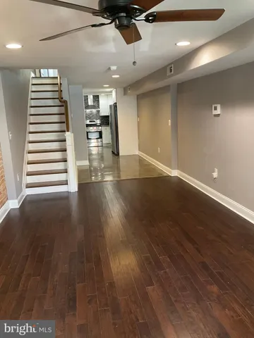a view of a room with wooden floor