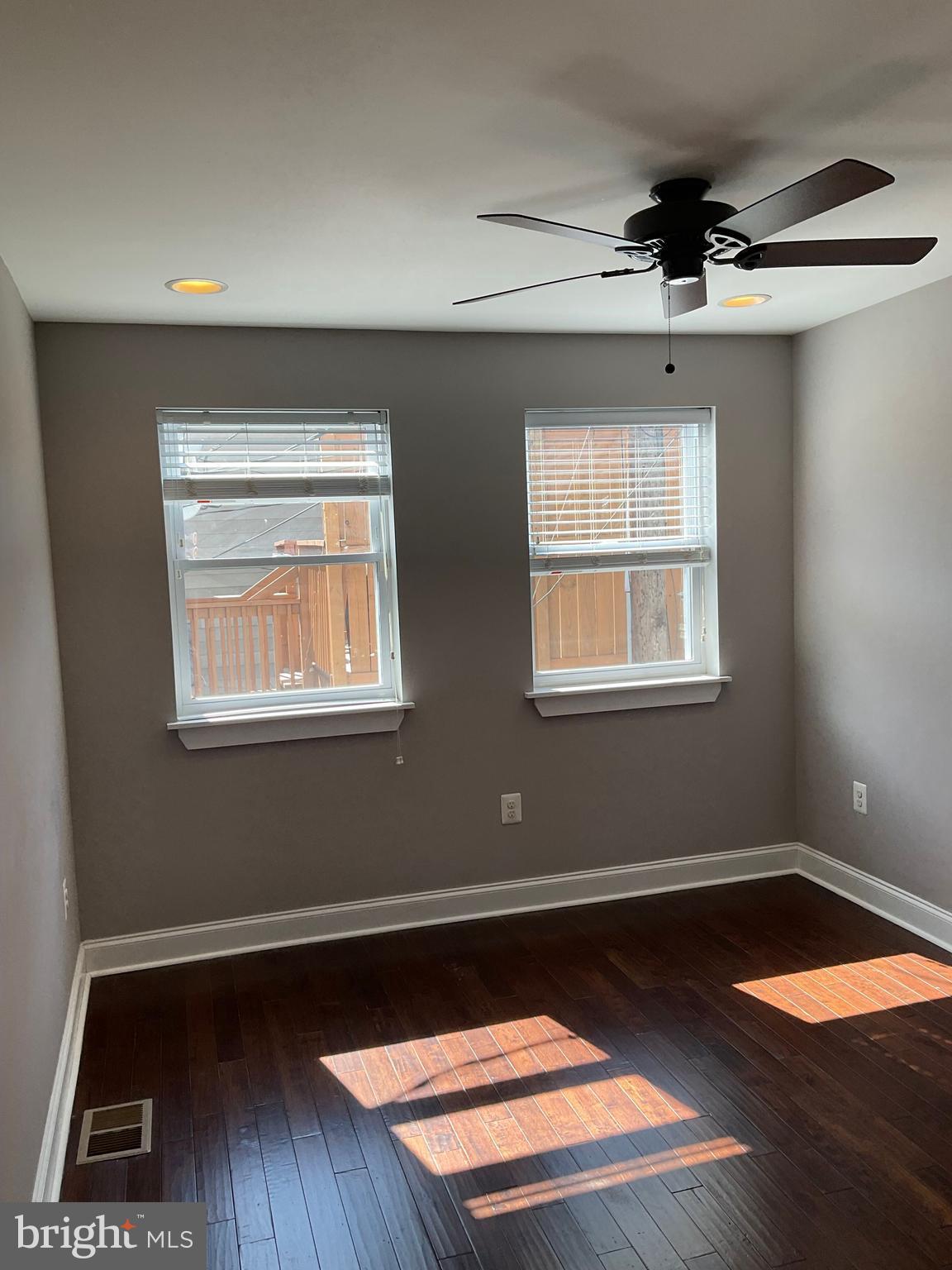 2437 Fleet Street Baltimore, MD 21224 - Photo 16 of 33 a view of an empty room with wooden floor and a window
