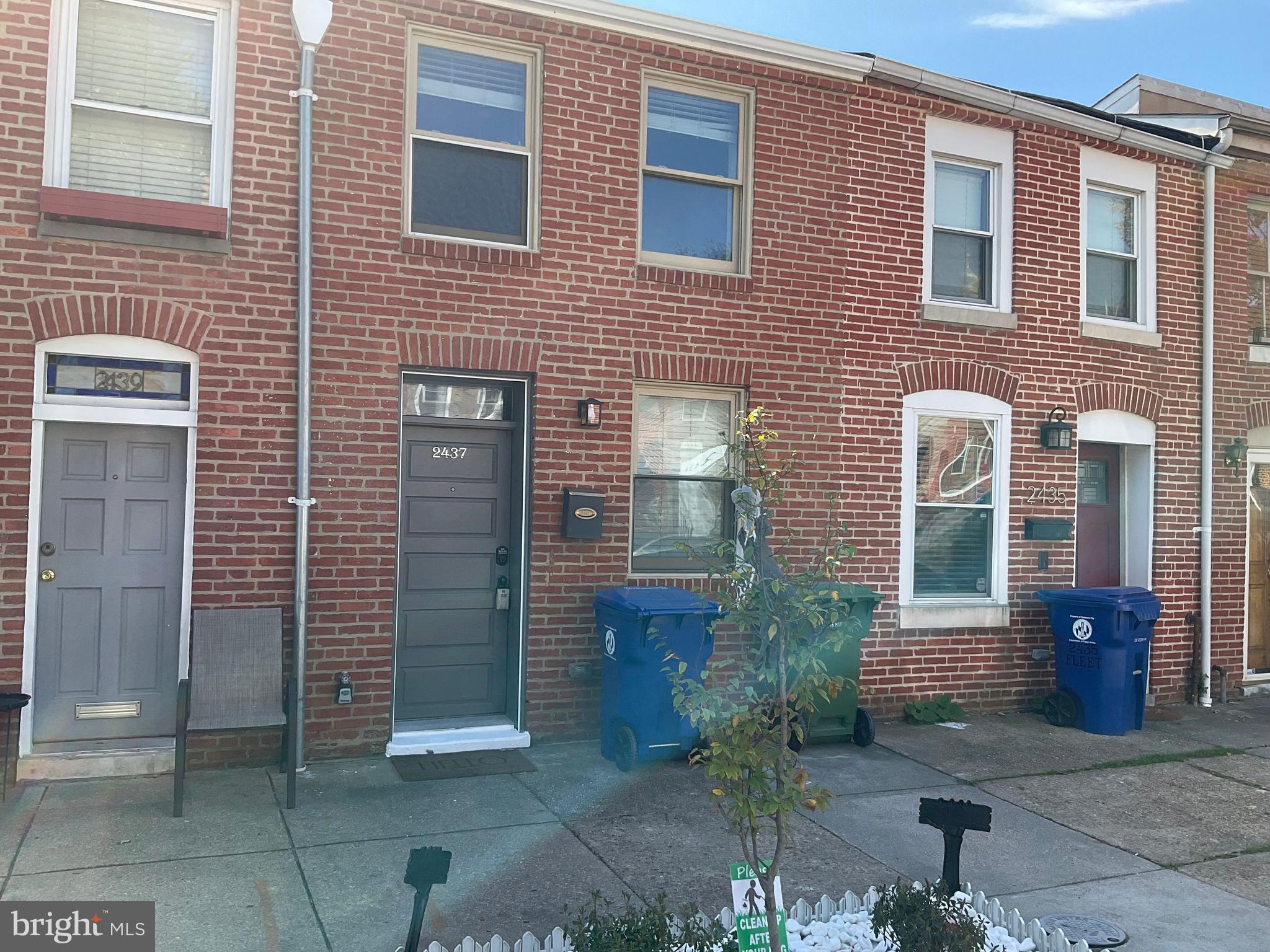 2437 Fleet Street Baltimore, MD 21224 - Photo 2 of 33 a view of brick house with potted plants