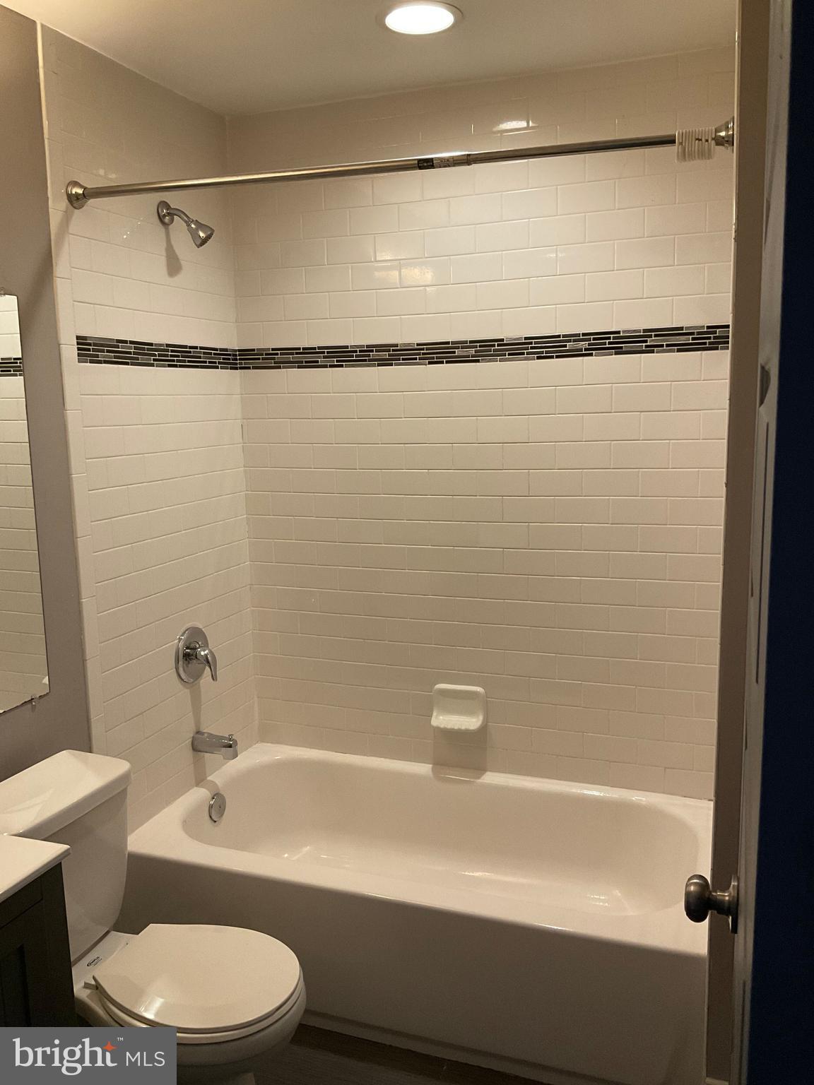 2437 Fleet Street Baltimore, MD 21224 - Photo 21 of 33 a bathroom with a shower a toilet and a tub