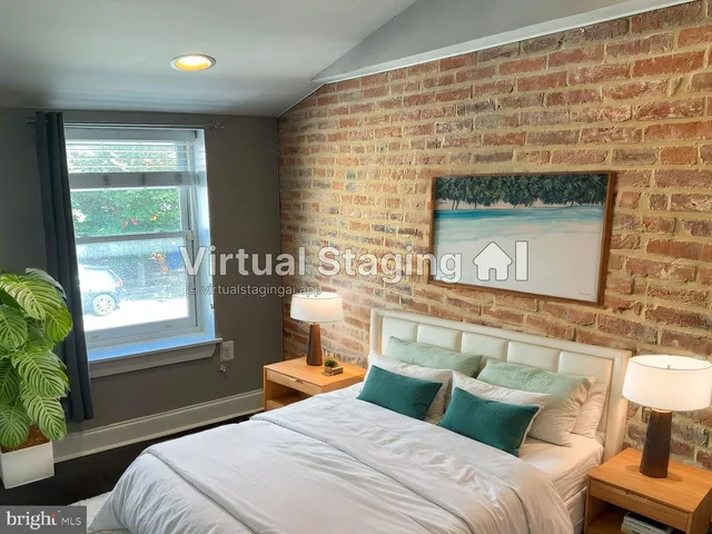 a bedroom with a bed a mirror and a window