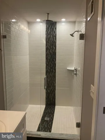 a bathroom with a shower and a sink