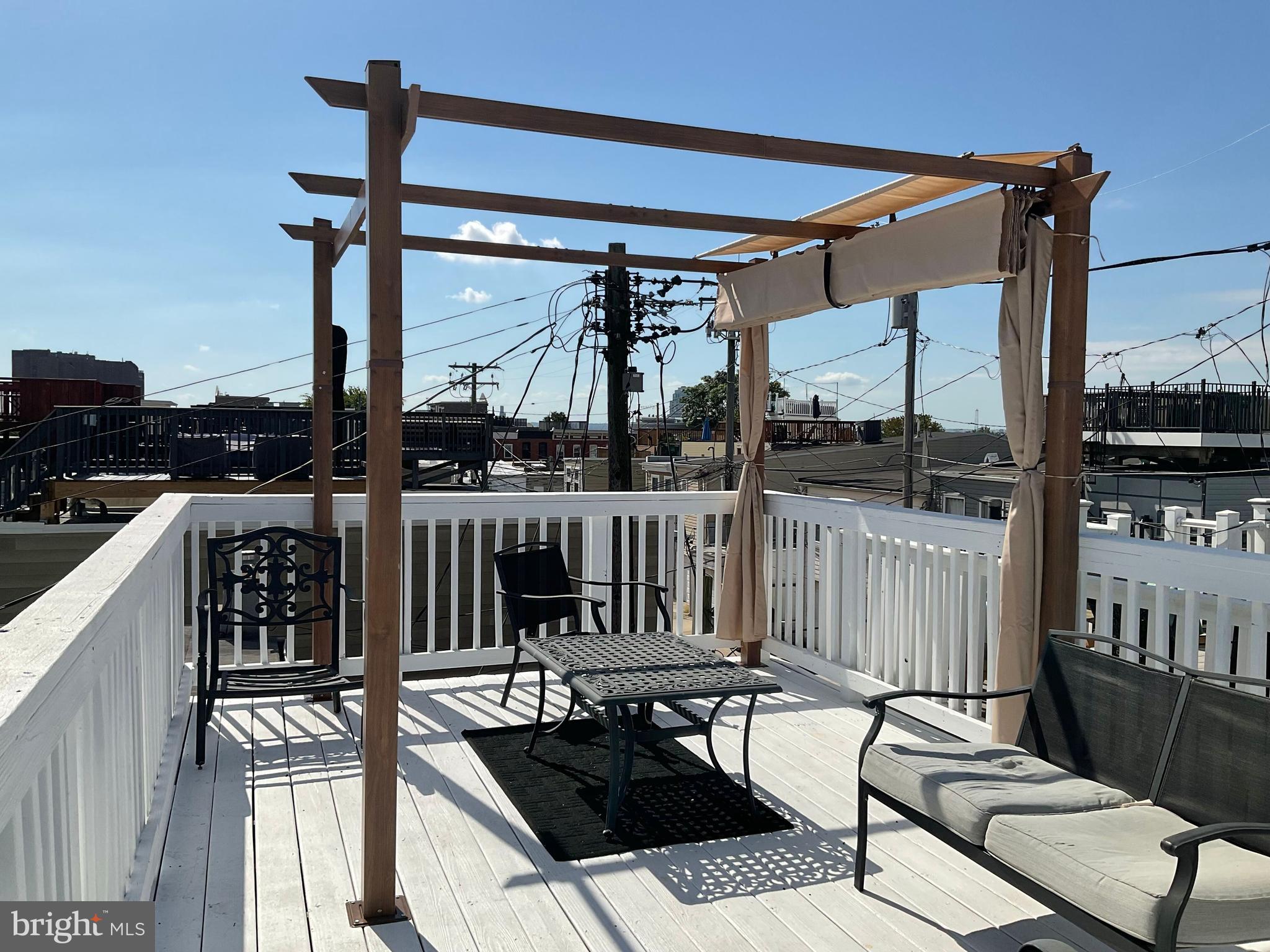 2437 Fleet Street Baltimore, MD 21224 - Photo 29 of 33 a roof deck with table and chairs