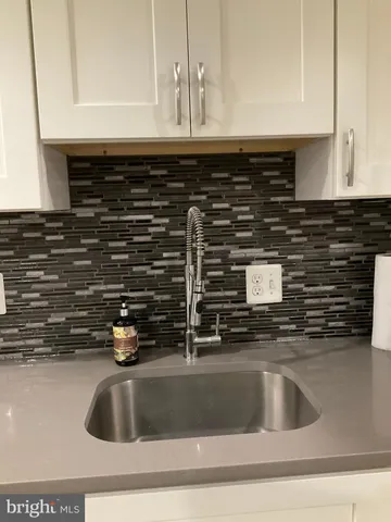 a kitchen with a sink and a stove