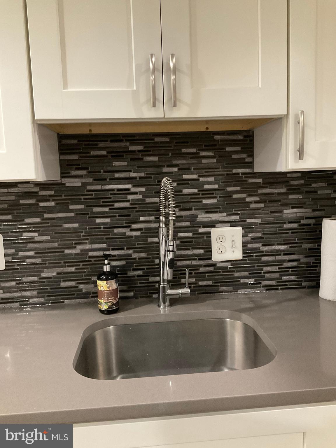 2437 Fleet Street Baltimore, MD 21224 - Photo 8 of 33 a kitchen with a sink and a stove