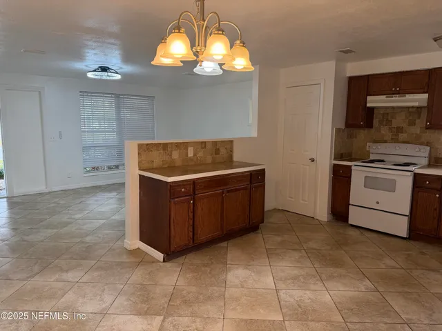 a kitchen with a stove and cabinets