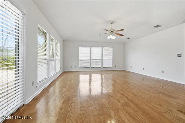 wooden floor in an empty room with a window