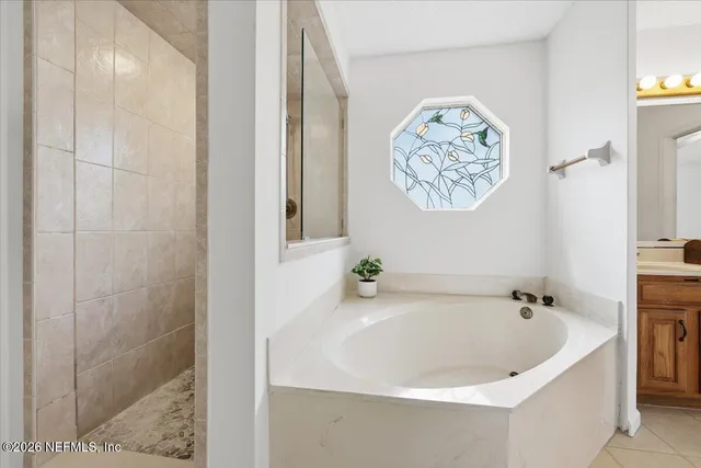 a white bath tub sitting next to a white wall