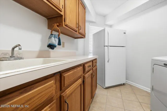 a kitchen with a sink and a refrigerator