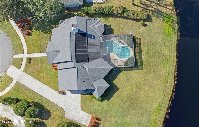 an aerial view of residential house with outdoor space and swimming pool