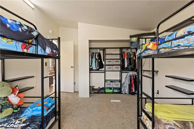 a bedroom with a bed and the view of en suite bathroom