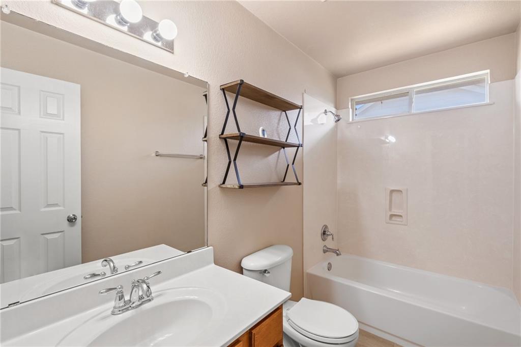 20224 Merlin Falcon Trail Pflugerville, TX 78660 - Photo 31 of 40 Functional full bathroom featuring a tub and shower combination with ample overhead light.
