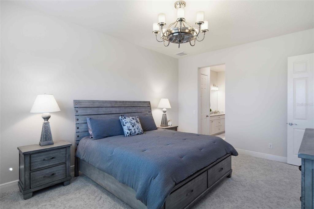 2210 North Peakview Loop Hernando, FL 34442 - Photo 54 of 100 a bedroom with a bed and a chandelier