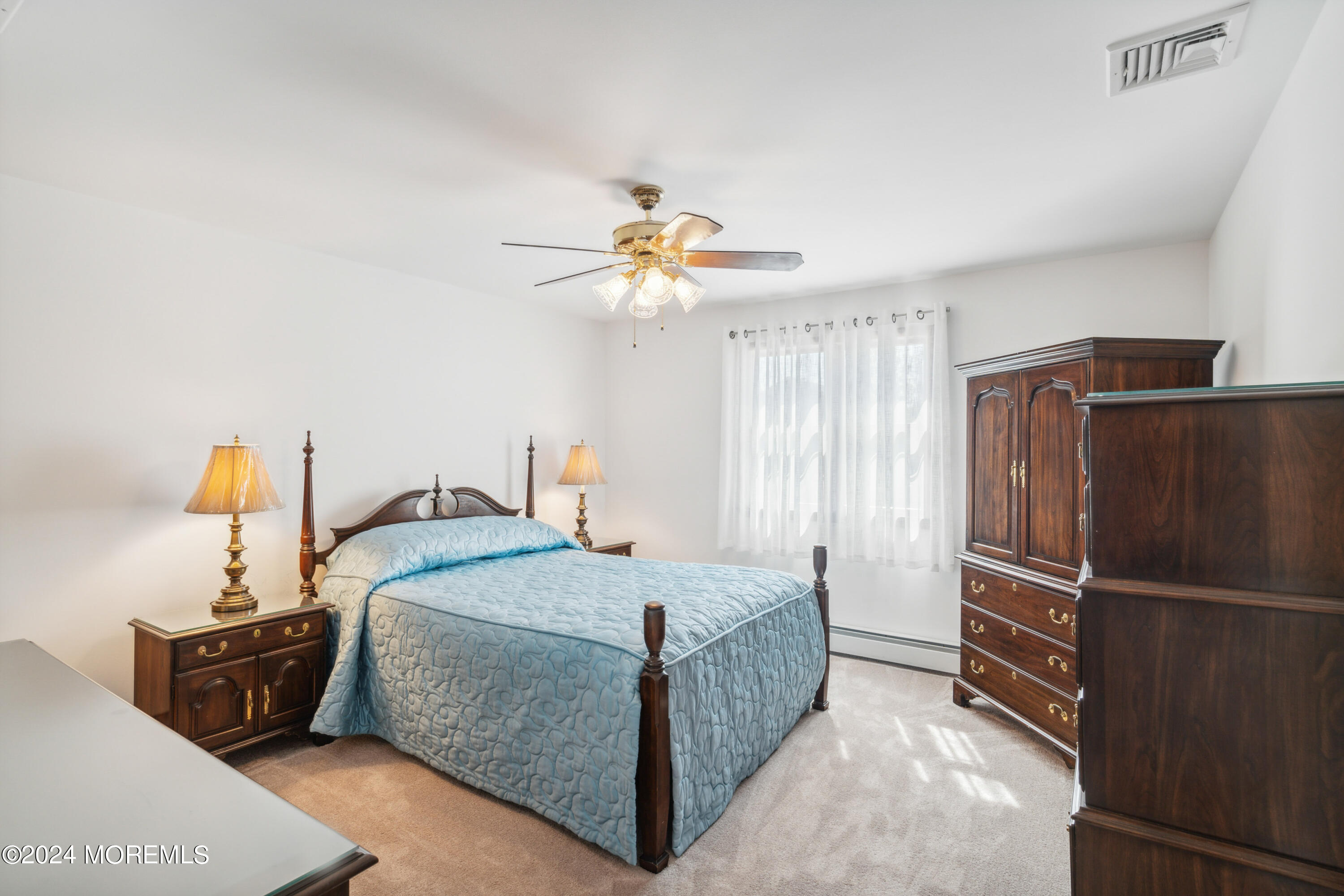 3 Garrett Road Toms River, NJ 08757 - Photo 16 of 24 a bedroom with a bed and a chandelier