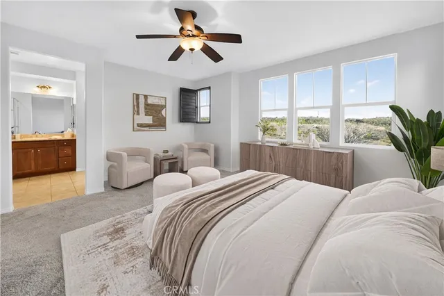 a bedroom with bed and a large window