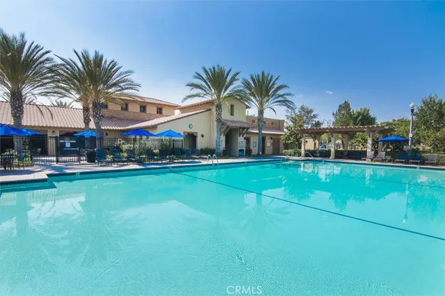 a view of multiple houses with swimming pool