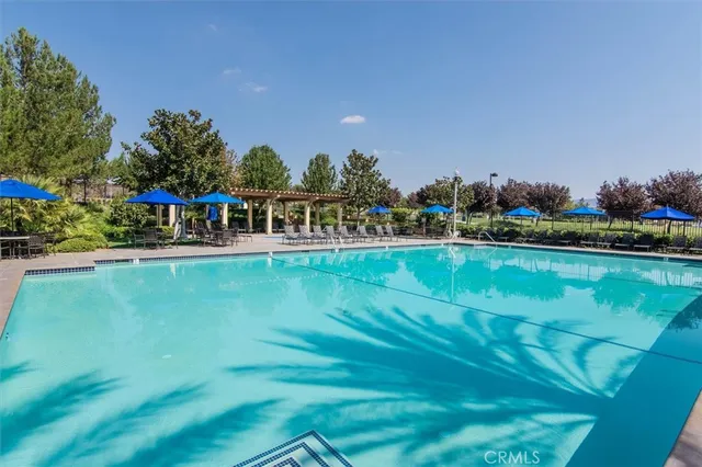 a view of multiple houses with swimming pool