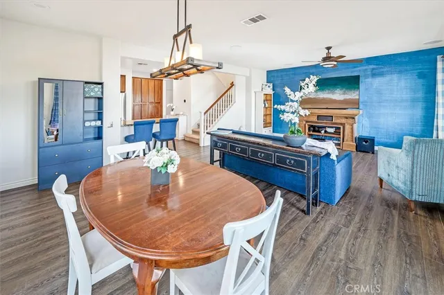 a dining room with furniture and wooden floor