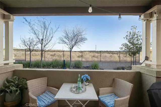 a roof deck with couches and potted plants
