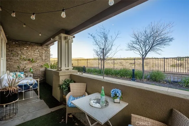 a view of a porch with furniture and wooden floor