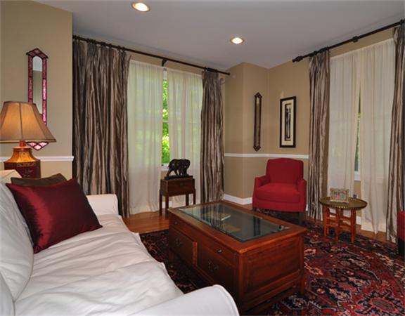 67 Brook Street Wellesley, MA 02482 - Photo 2 of 14 a living room with furniture a large window and a flat screen tv