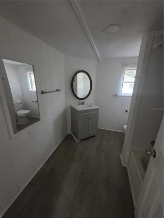 a view of a room with furniture and mirror