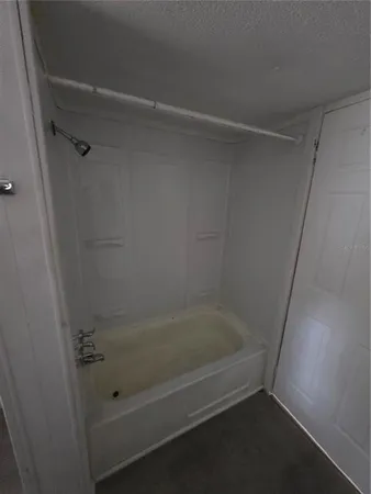 a view of an empty room and wooden floor