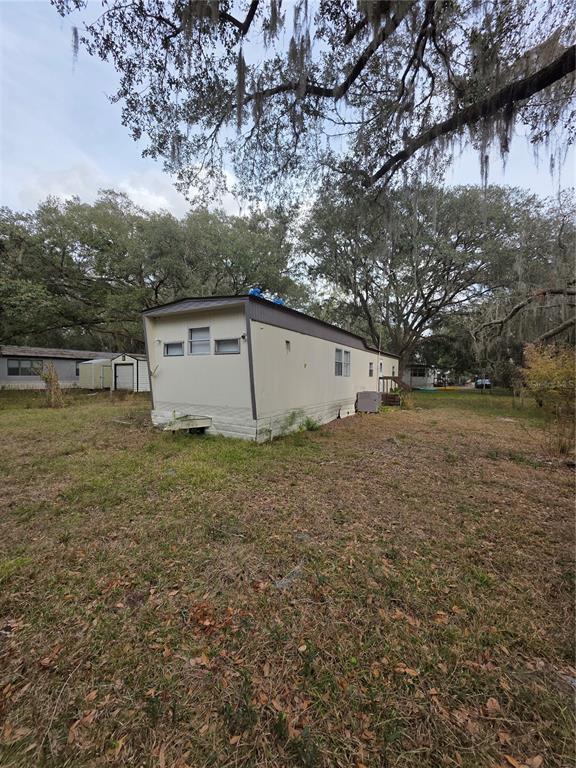 204 Johntry Road Hawthorne, FL 32640 - Photo 2 of 16 a view of a barn in the middle of a yard