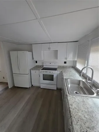 a kitchen that has a sink and a stove