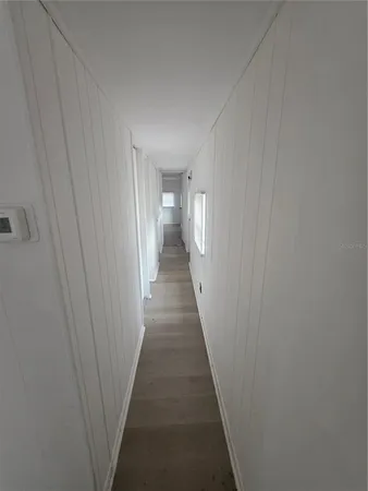 a view of a hallway with a wooden floor