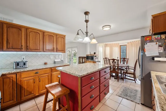 a view of a dining room with furniture and a window