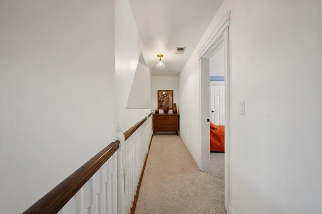 a room with chandelier fan and windows