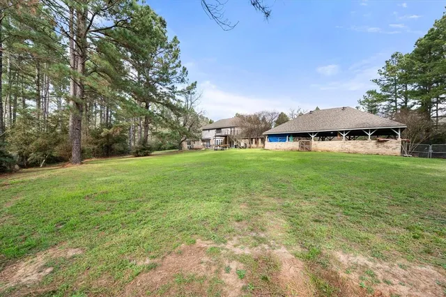 a front view of a house with a garden and trees