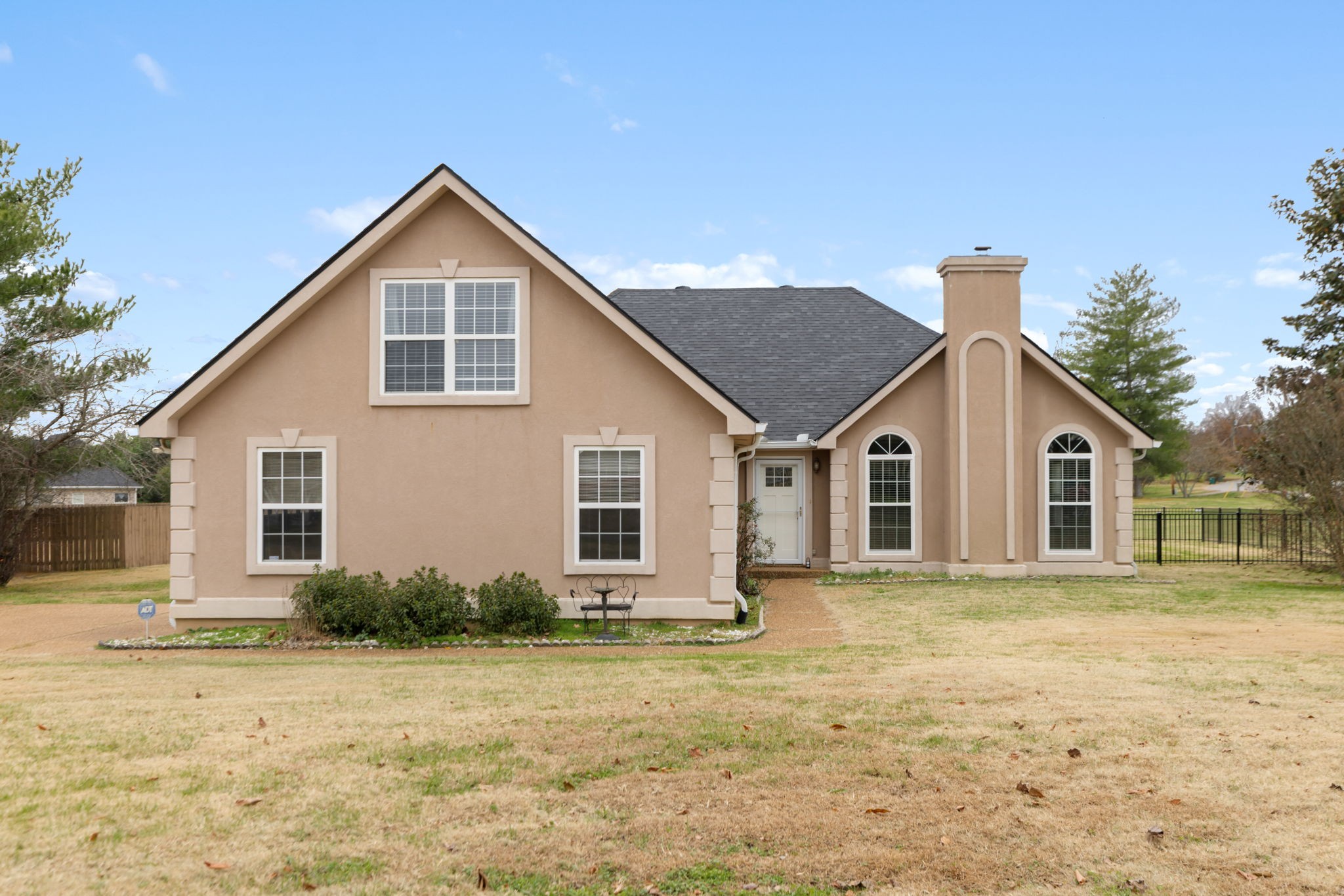 a front view of a house with a yard