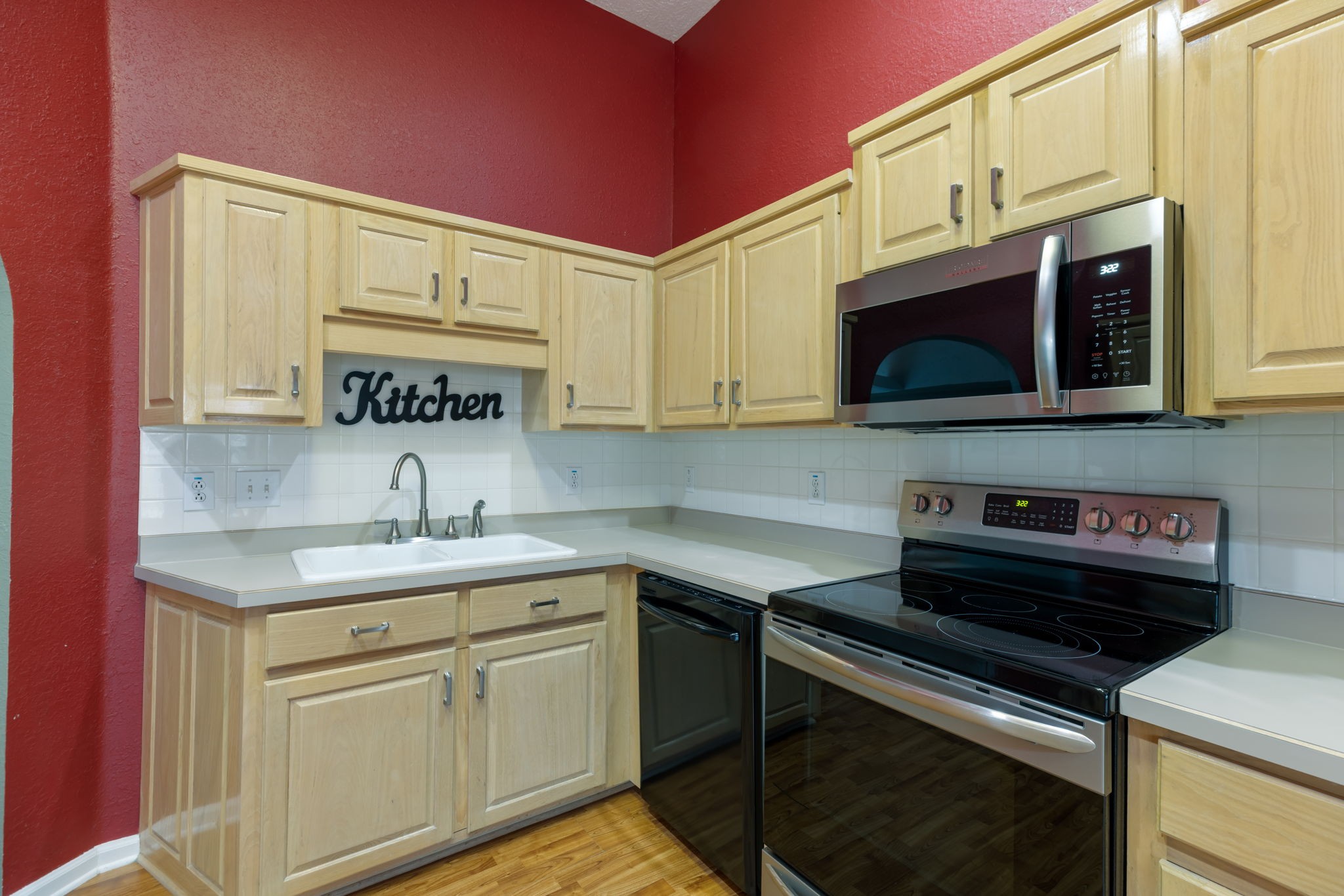 1240 Hunters Point Lane Spring Hill, TN 37174 - Photo 20 of 58 a kitchen with stainless steel appliances a sink stove and microwave
