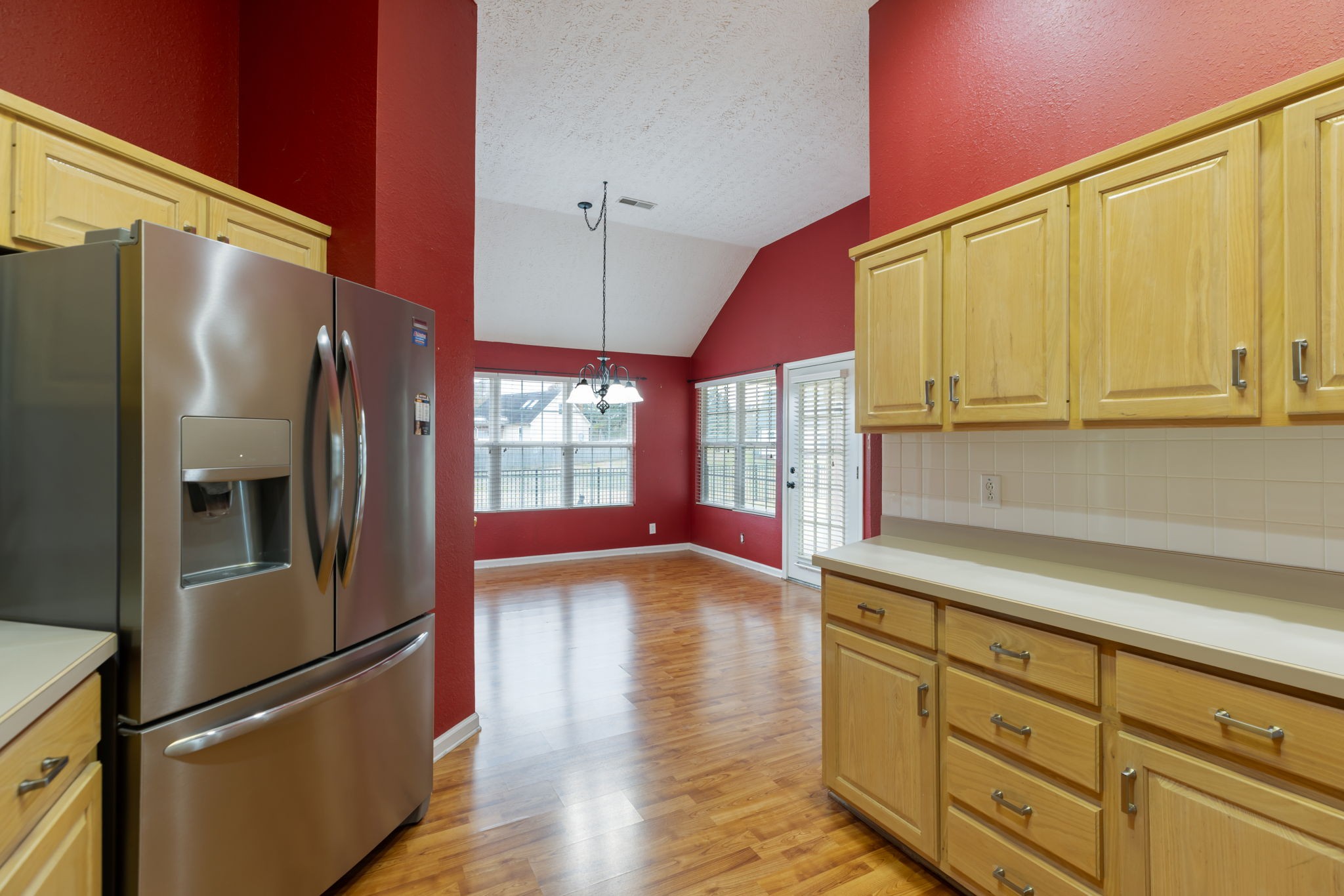 1240 Hunters Point Lane Spring Hill, TN 37174 - Photo 21 of 58 a kitchen with stainless steel appliances granite countertop a refrigerator a oven and white cabinets with wooden floors