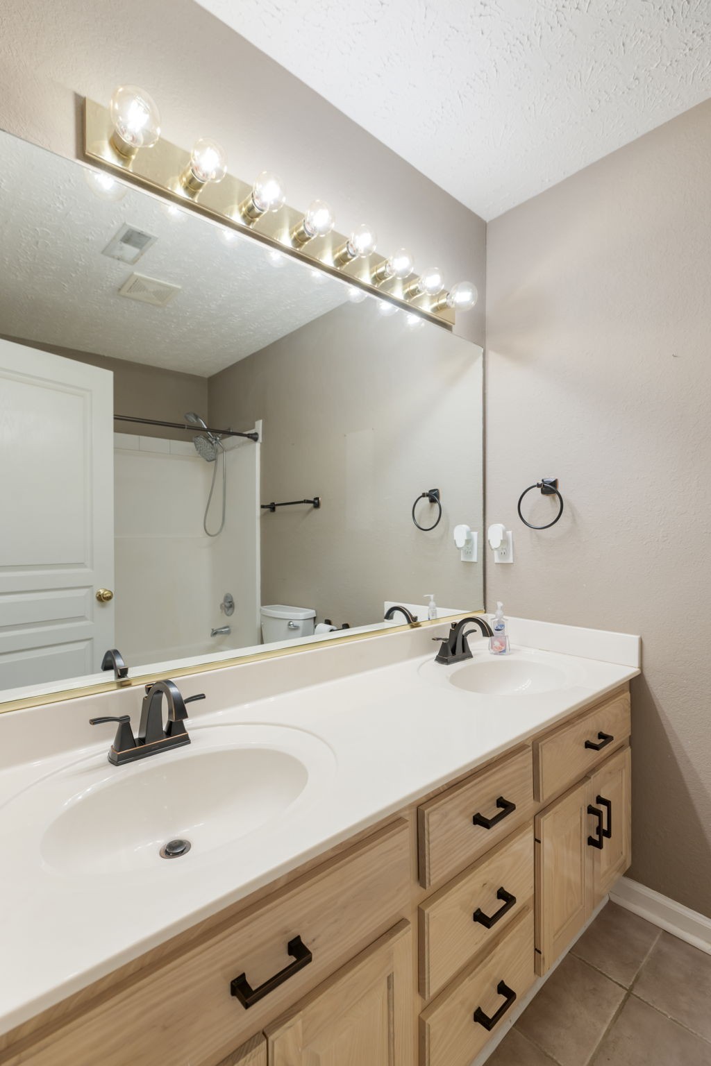 1240 Hunters Point Lane Spring Hill, TN 37174 - Photo 26 of 58 a bathroom with a double vanity sink and a mirror