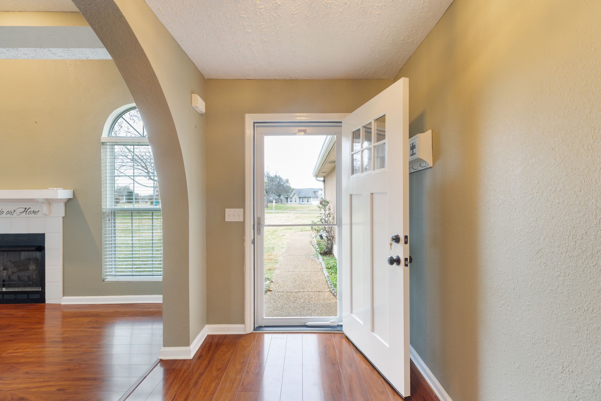 1240 Hunters Point Lane Spring Hill, TN 37174 - Photo 5 of 58 a view of a livingroom with wooden floor and a fireplace