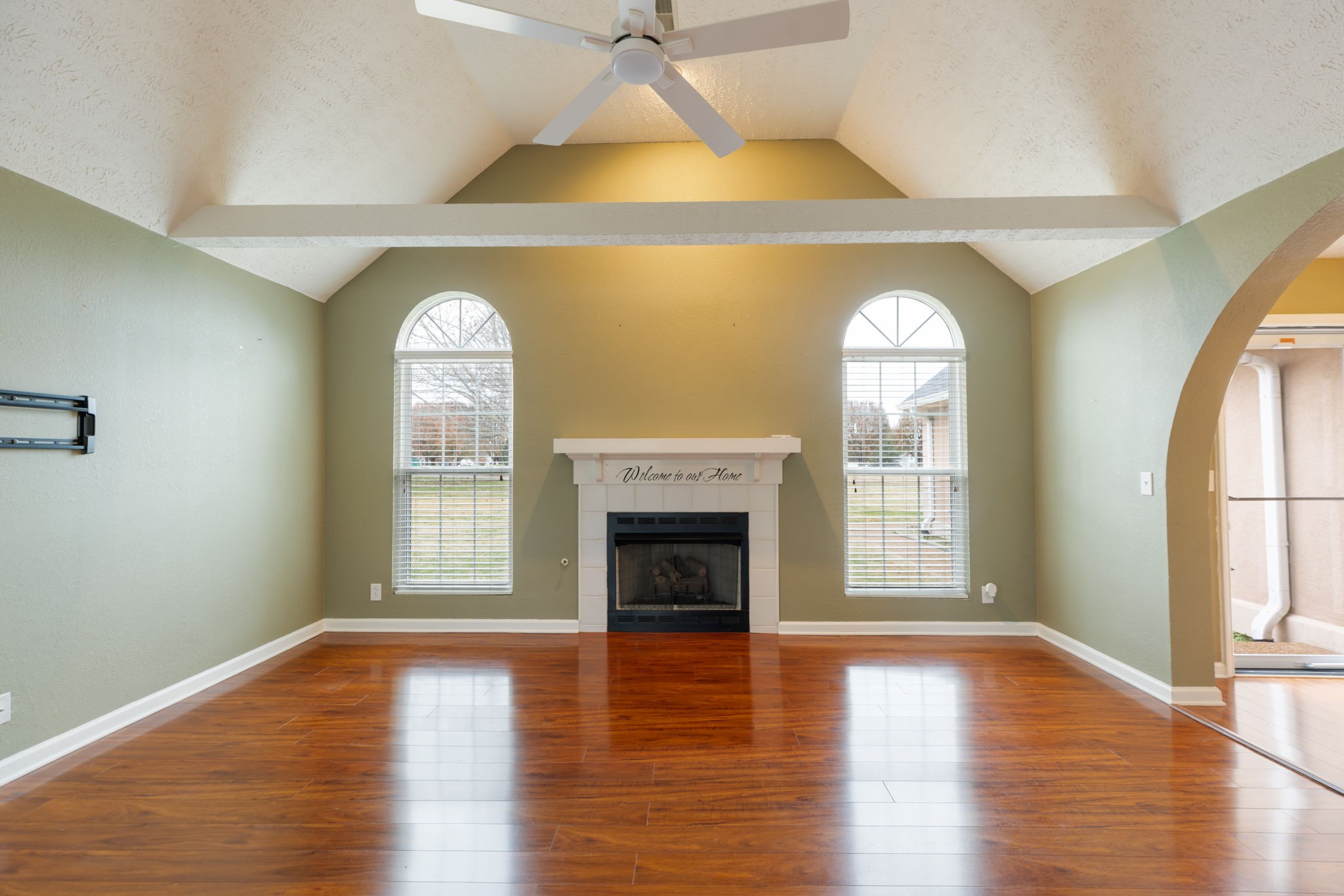 1240 Hunters Point Lane Spring Hill, TN 37174 - Photo 7 of 58 an empty room with wooden floor fireplace and windows