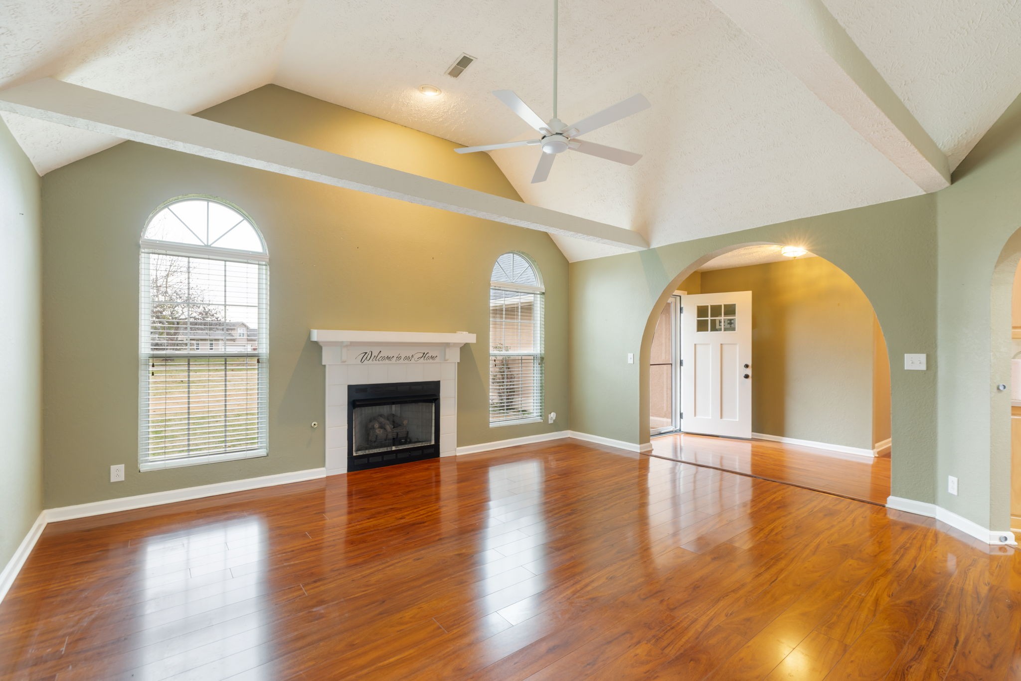 1240 Hunters Point Lane Spring Hill, TN 37174 - Photo 8 of 58 an empty room with wooden floor fireplace and windows